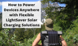 Hiker with a LightSaver Portable Solar Charger on his back looking through forest greenery at a mountain.